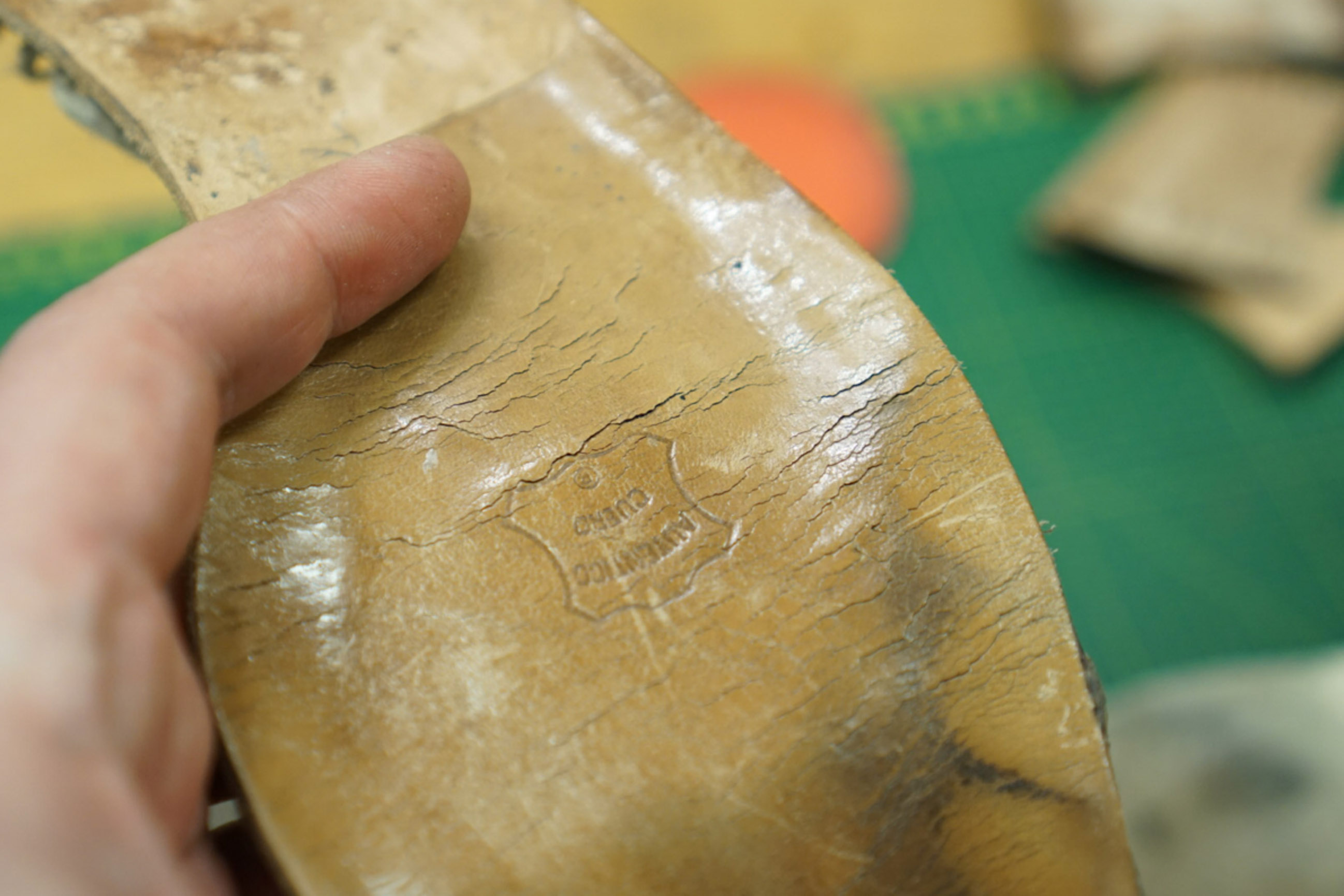 A cracked insole removed from an old shoe.